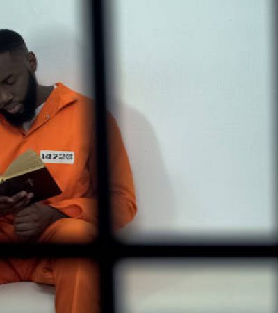African-american prisoner reading holy bible, convicted sinner, religion